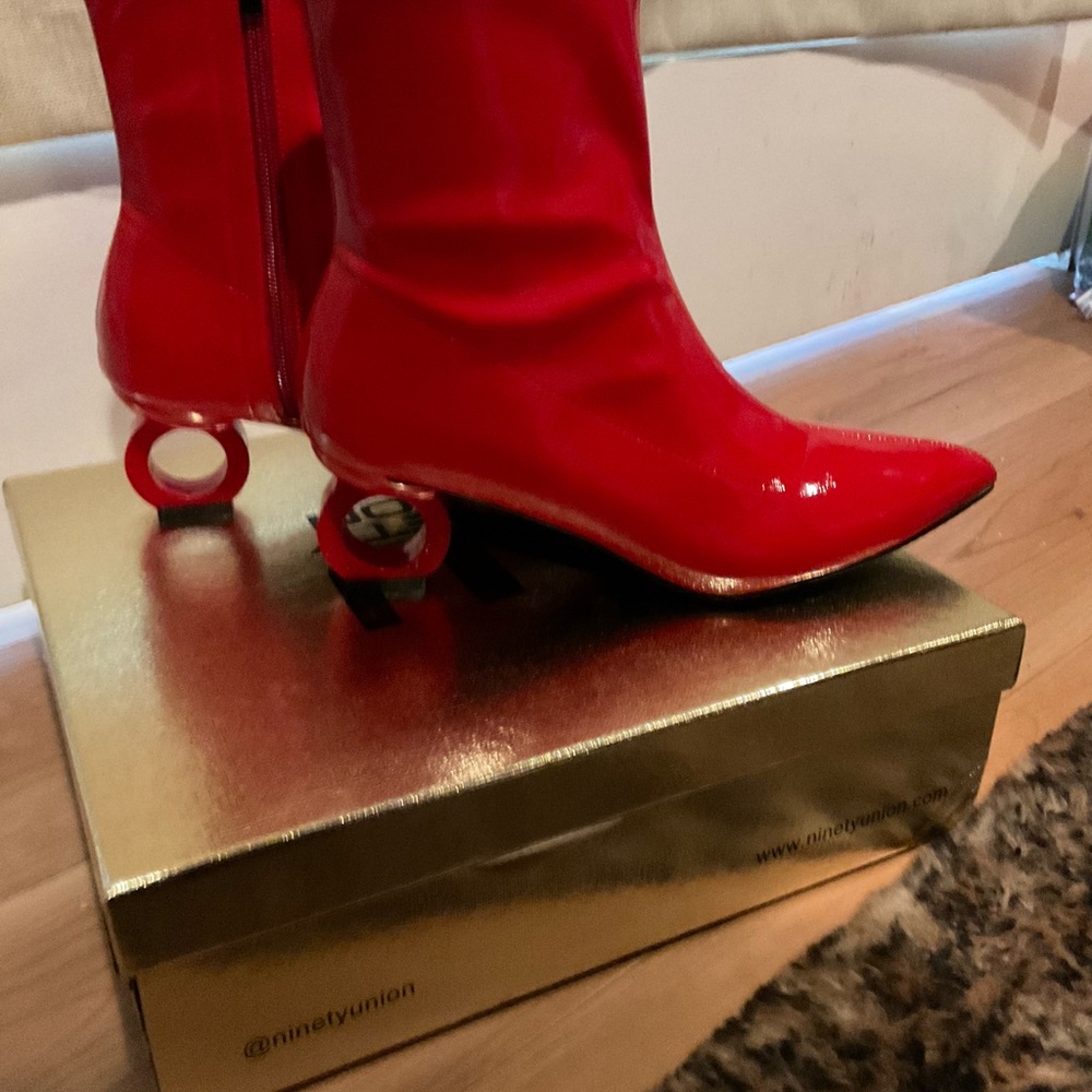 Striking Red Heeled Boots with Pointed Toe and Unique Spherical Heel